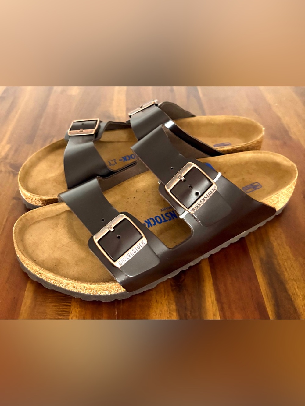 Birkenstock Men’s Arizona Two-Buckle Sandal — Dark Brown with Rose Gold Buckles.